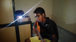 Me playing my guitar in my room.